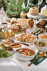 Christmas Eve supper with traditional Polish dishes and pastries on festive table