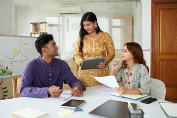 Team of marketing department managers discussing research results in daily meeting