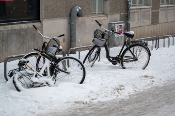 Bike parked in bike rack a snowy day