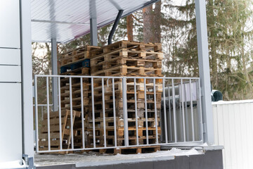 Stack of Wooden Pallets Arranged for Shipment at Store Unloading Area
