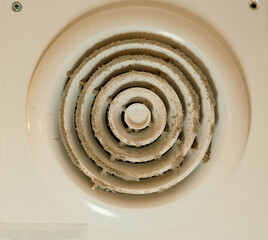 Dirty electric duct fan of bathroom extractor hood, needing cleaning for proper ventilation
