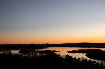 sunset in the mountains from the hill with view of oslo fjord