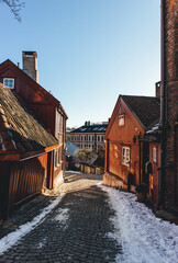 old houses in the city on warm end of winter day with snow on sunny morning 