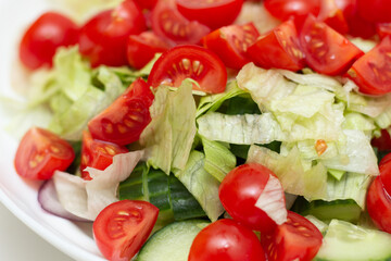 Vegetable salad macro photography. tomatoes, lettuce, greens and cucumbers