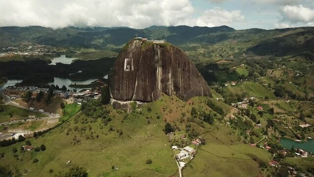 Aerial drone footage of El Penon de Guatape near Medellin in Antioquia, Colombia. Large and unique alone rock with stairs to the top, touristic place. Big stone in Colombia. High quality 4k footage.