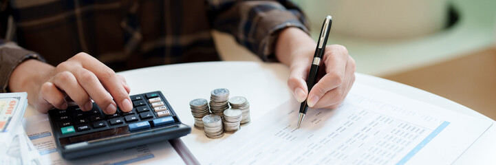 Female calculating personal financial for future plan at her home, taxes payment..