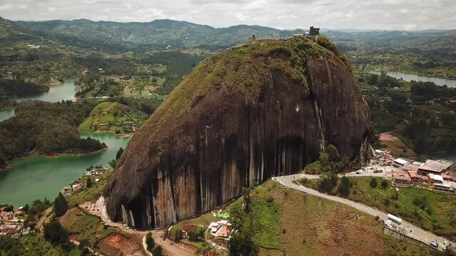 Aerial drone footage of El Penon de Guatape near Medellin in Antioquia, Colombia. Large and unique alone rock with stairs to the top, touristic place. Big stone in Colombia. High quality 4k footage.