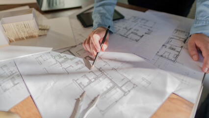 Architects interior designer hands working with Blue prints and documents for a home...