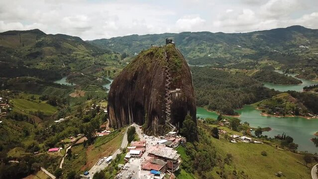 Aerial drone footage of El Penon de Guatape near Medellin in Antioquia, Colombia. Large and unique alone rock with stairs to the top, touristic place. Big stone in Colombia. High quality 4k footage.