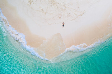 Daku island view from the sky. Man relaxing taking sunbath on the beach.shot taken with drone above the beautiful scene. concept about travel, nature, and marine landscapes
