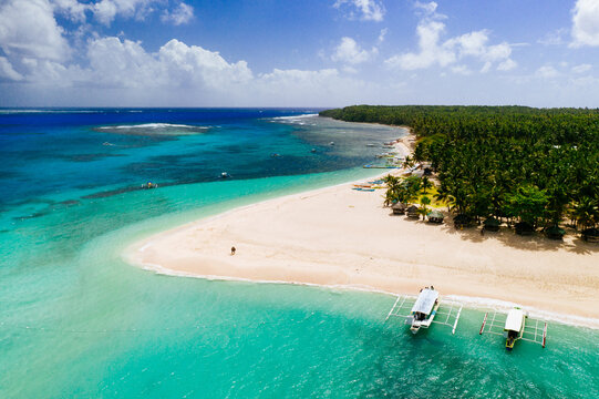 Daku island view from the sky. Man relaxing taking sunbath on the beach.shot taken with drone above the beautiful scene. concept about travel, nature, and marine landscapes