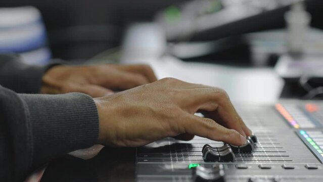 Dj controller, knobs and faders,Sound production concept. Sound mixing panel is being regulated by a producer, sound studio equipment