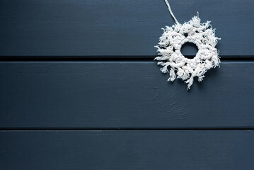 Knitted snowflake in the macrame technique on wooden boards, free space, flatl lay... - obrazy, fototapety, plakaty