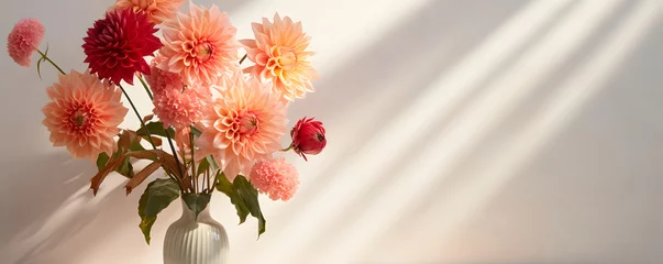 Schilderijen op glas Beautiful autumn flower bouquet with red, pink dahlia and orange berry in vase on table. Aesthetic sun light shadow on empty neutral wall background, copy space, wedding or holiday arrangement  © Chris
