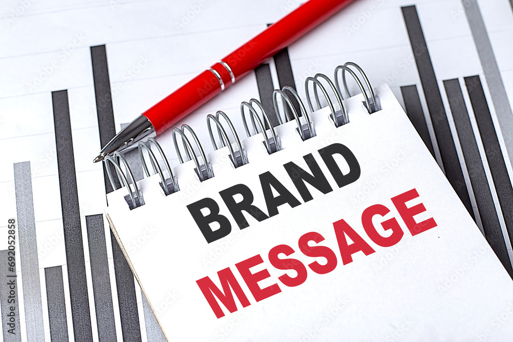 Aufkleber brand message text written on notebook with pen on chart