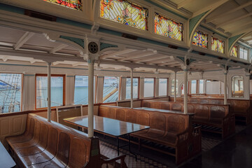 Classic historic interiors of old ferry boat ship liner with wooden paneling, brass glass windows...