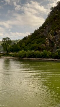 Traveling along the Rhine River with scenic views of the medieval landscape of St. Goarshausen, Germany and the Loreley slate rock. Located within the Rhine Gorge (Middle Rhine).