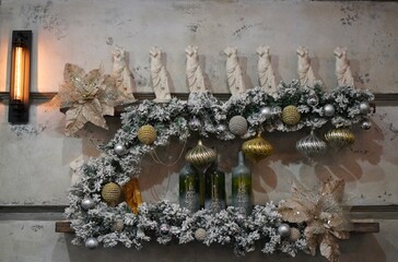 wooden shelf with vintage sculptures of a girl with Christmas tree garlands with New Year's balls in the winter before Christmas