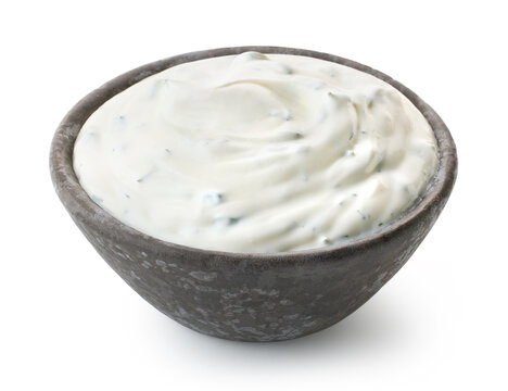 Dark grey ceramic bowl of fresh sour cream dip sauce with herbs