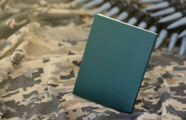 Ukrainian military ID on fabric with texture of pixeled camouflage. Cloth with camo pattern in...