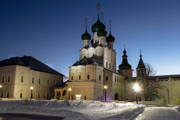 View of the courtyard of the Rostov Kremlin on a winter evening with the Gate Church of St. John...