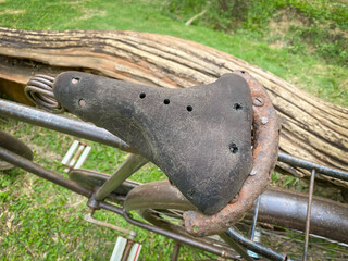 Classic old fashioned black gents roadster bicycle saddle from early 20th century parked in the...