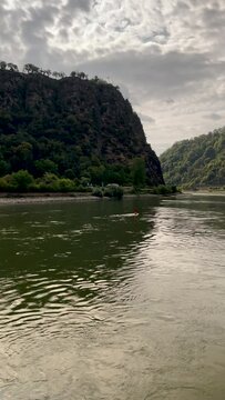 Traveling along the Rhine River with scenic views of the medieval landscape of St. Goarshausen, Germany and the Loreley slate rock. Located within the Rhine Gorge (Middle Rhine).