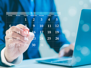 Businessman making red circles on important days on the calendar Important appointment dates,...
