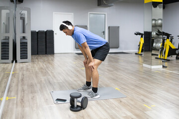 Man resting after workout in modern gym