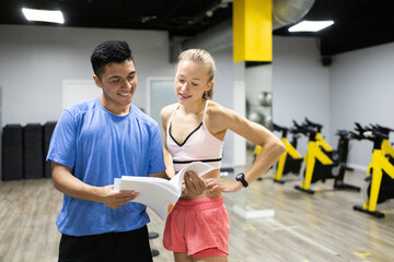 Fitness instructor discussing workout plan with client