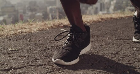 Fitness, closeup and black man tie shoes for exercise, workout and running for cardio outdoor in road. Sports, health and zoom of African athlete with laces for race, competition or marathon training