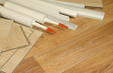 Set of items for PVC ceiling indoor works. Assembly adhesive bottles and PVC panels with plastic...