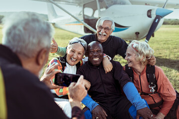 Group of senior friends celebrating their skydiving adventure together