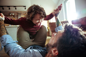 Happy father and son playing at home