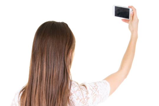 Back view of beautiful young woman making selfie on a smartphone on white png transparent background - Powered by Adobe