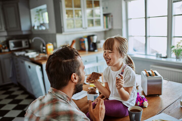 Joyful Father and Daughter Breakfast Time with Chocolate Spread