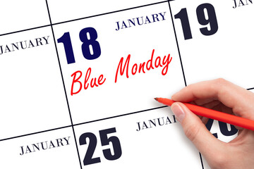 January 18. Hand writing text Blue Monday on calendar date. Save the date.