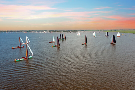 ial from traditional skutsjesilen with ancient boats on the Heeger meer in Friesland in the Netherlands at sunset