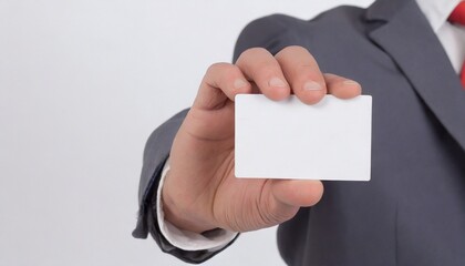Cropped man in suit pointing finger on empty debit or business card for copy space