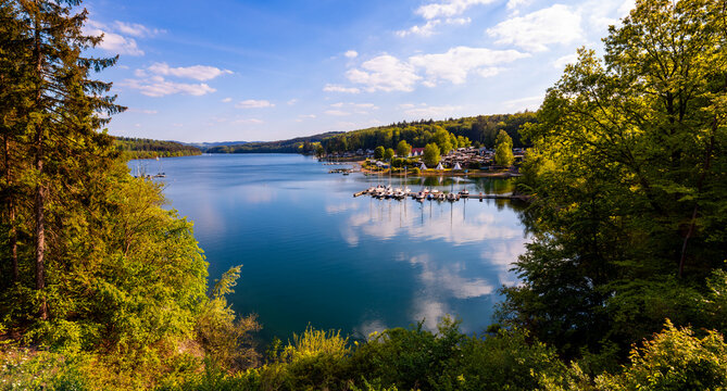 Panoramic view of &ldquo;Sorpesee&ldquo;, a drinking water reservoir and popular recreation and sports area near Sundern, Sauerland Germany with sailing boats and idyllic green nature on a sunny spring day. 