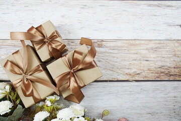 Gift boxes with gold ribbon on wooden background