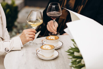Couple drinking wine in a cafe on their anniversary