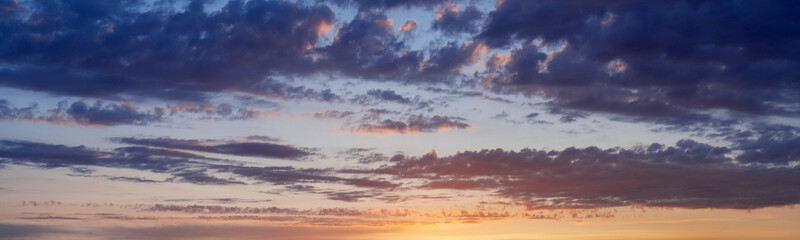 Sunset sky with clouds. Blue and yellow natural background