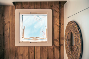View from below of a skylight installed in a Nordic style camper van