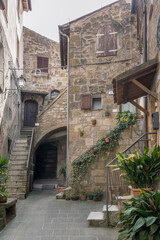 Fototapeta na wymiar stairs in narrow lane at medieval hilltop village, Pitigliano, Italy