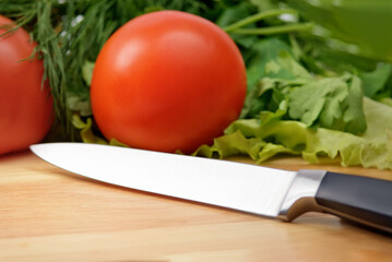 Chopping board with tomato, parsley and knife