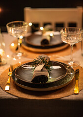 winter holidays, dinner party and celebration concept - close up of scandinavian christmas table serving with burning candles at home at night - obrazy, fototapety, plakaty