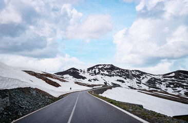 Asphalt road in Alps mountains. Road trip concept. Beautiful landscape.