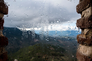 Condensation on a glass with the mountain in the background