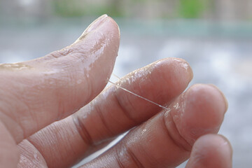 adult hands wet with mucus.